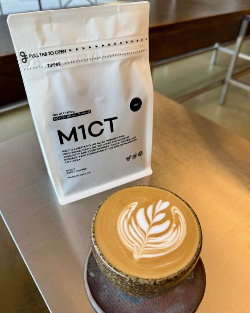 A flat white and a bag of coffee from M1CT coffee.