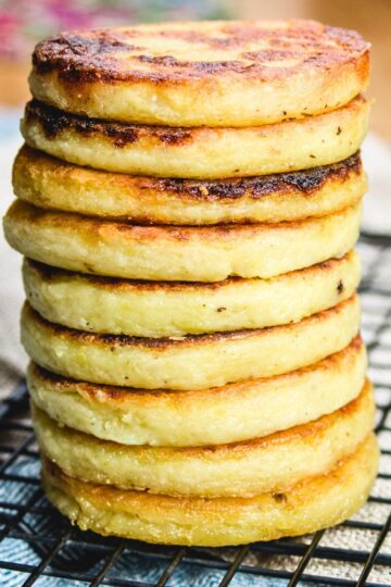 A stack of potato scones on a cooling rack.