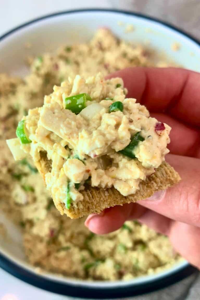 Tofu salad piled on top of a Triscuit cracker.