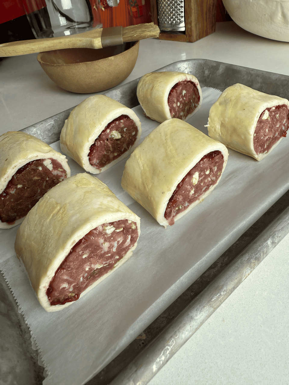 Chilled and sliced sausage rolls, ready to bake.