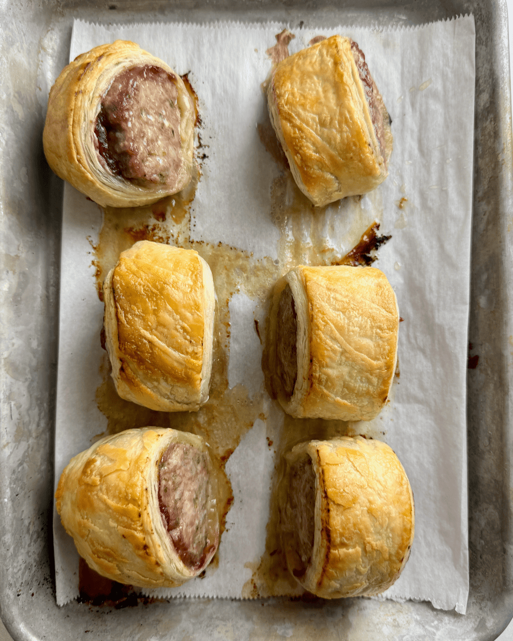 Top down image of the sausage rolls on a baking sheet.