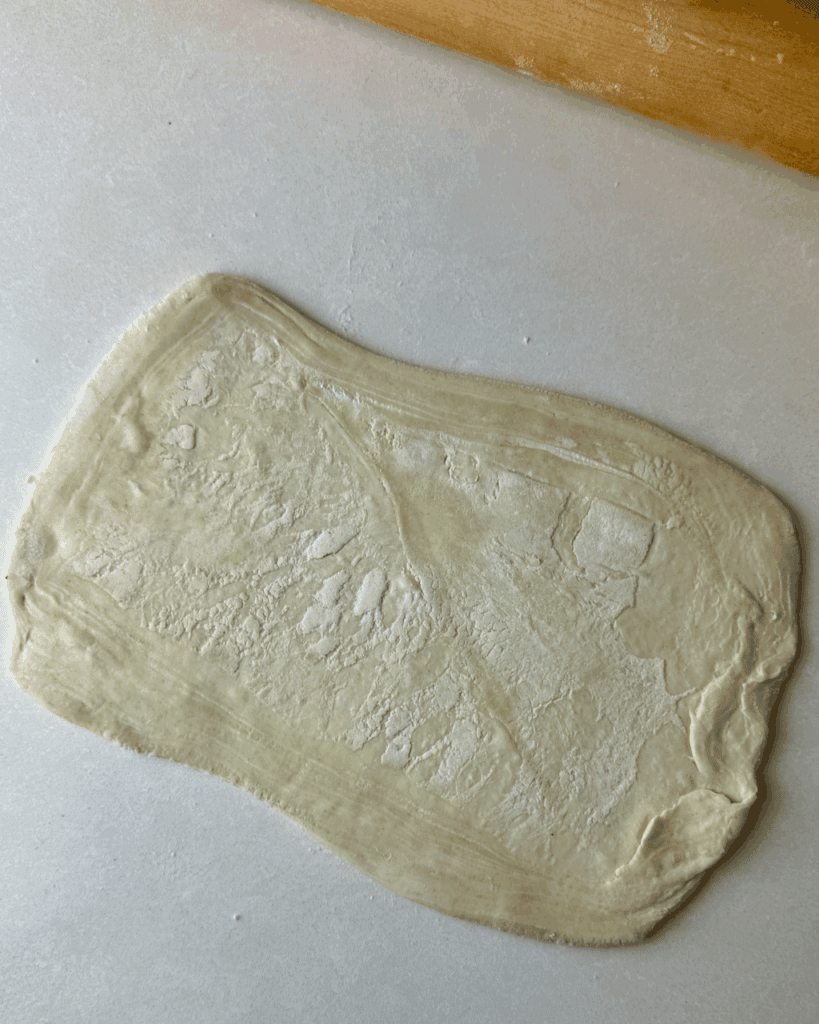 Raw pastry dough ready for turkey cranberry sausage rolls preparation.