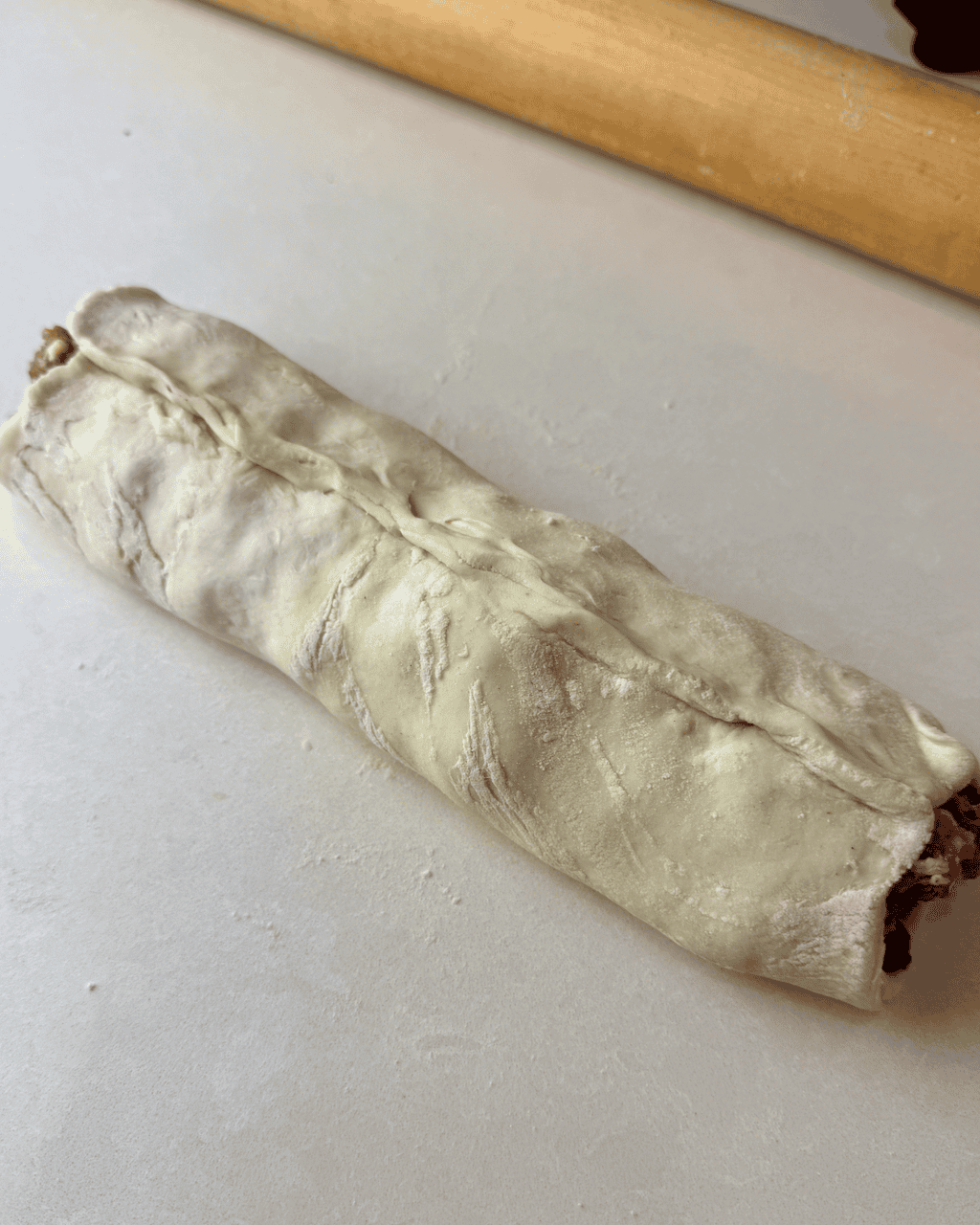 The sausage roll log once the pastry is wrapped around the sausage filling.