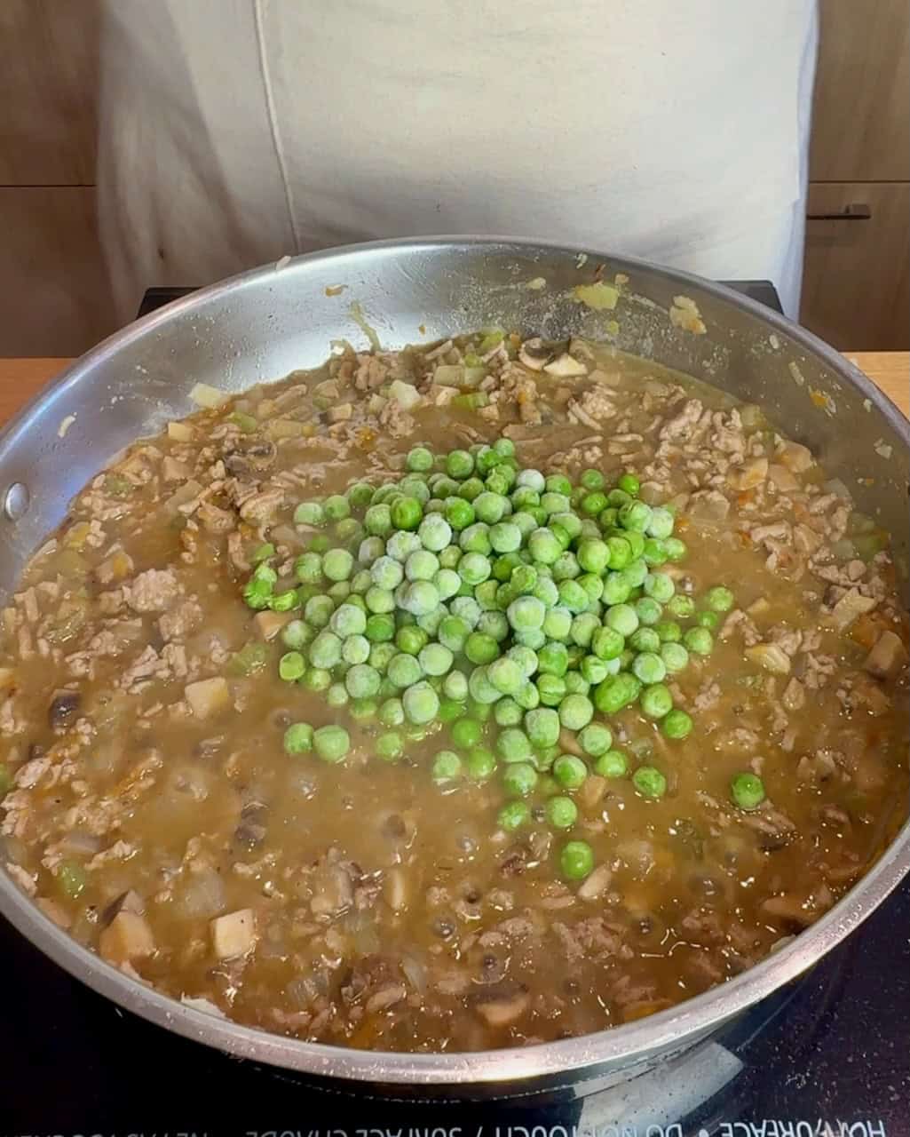 Adding the frozen peas towards the end.