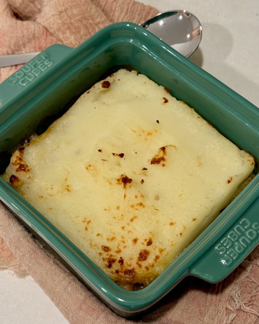 The baked portion of turkey shepherd's pie in a single serving dish.