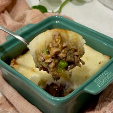 A scoop of turkey shepherd's pie from a single portion dish.