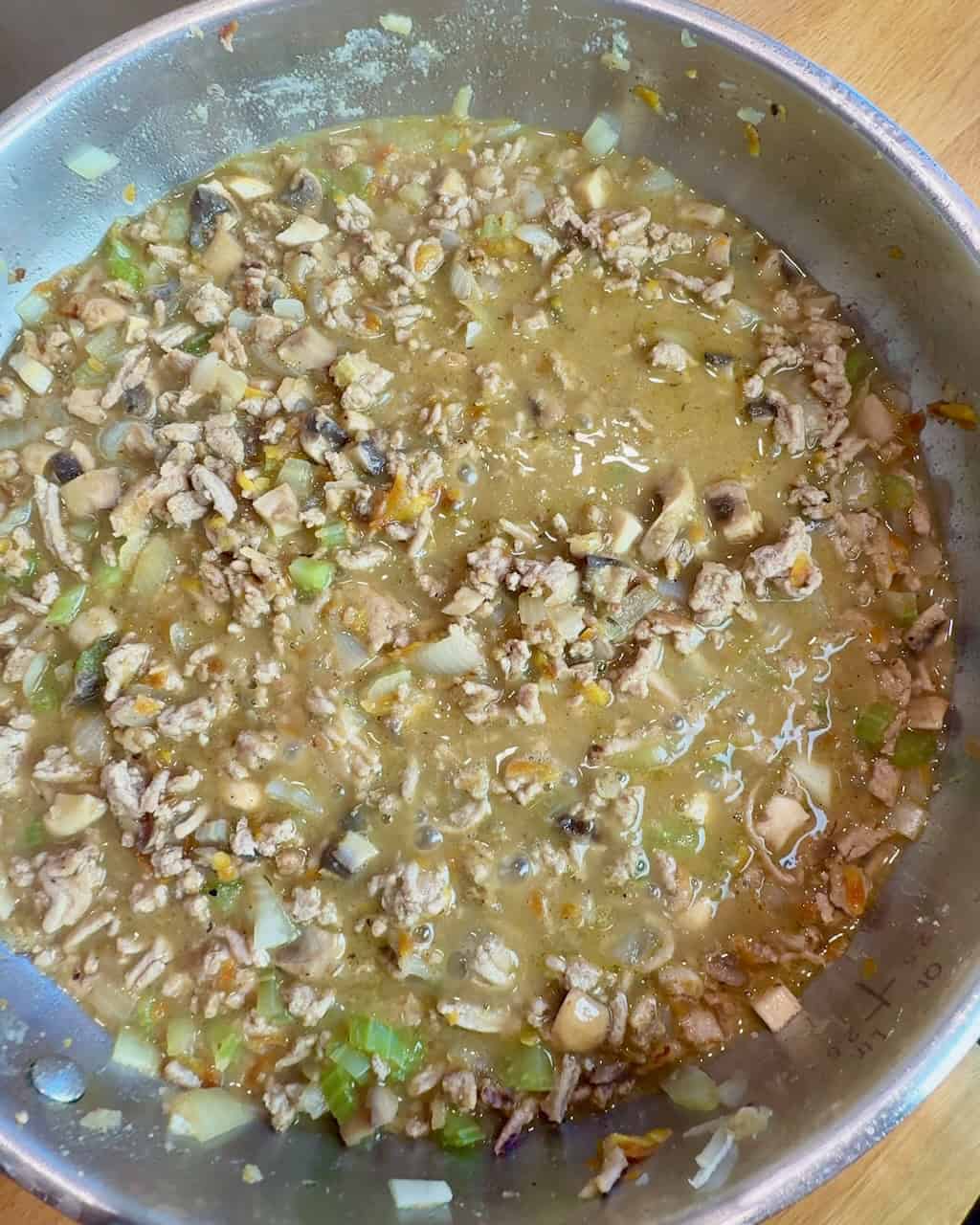 The flour and broth are added, and the gravy starts to form.